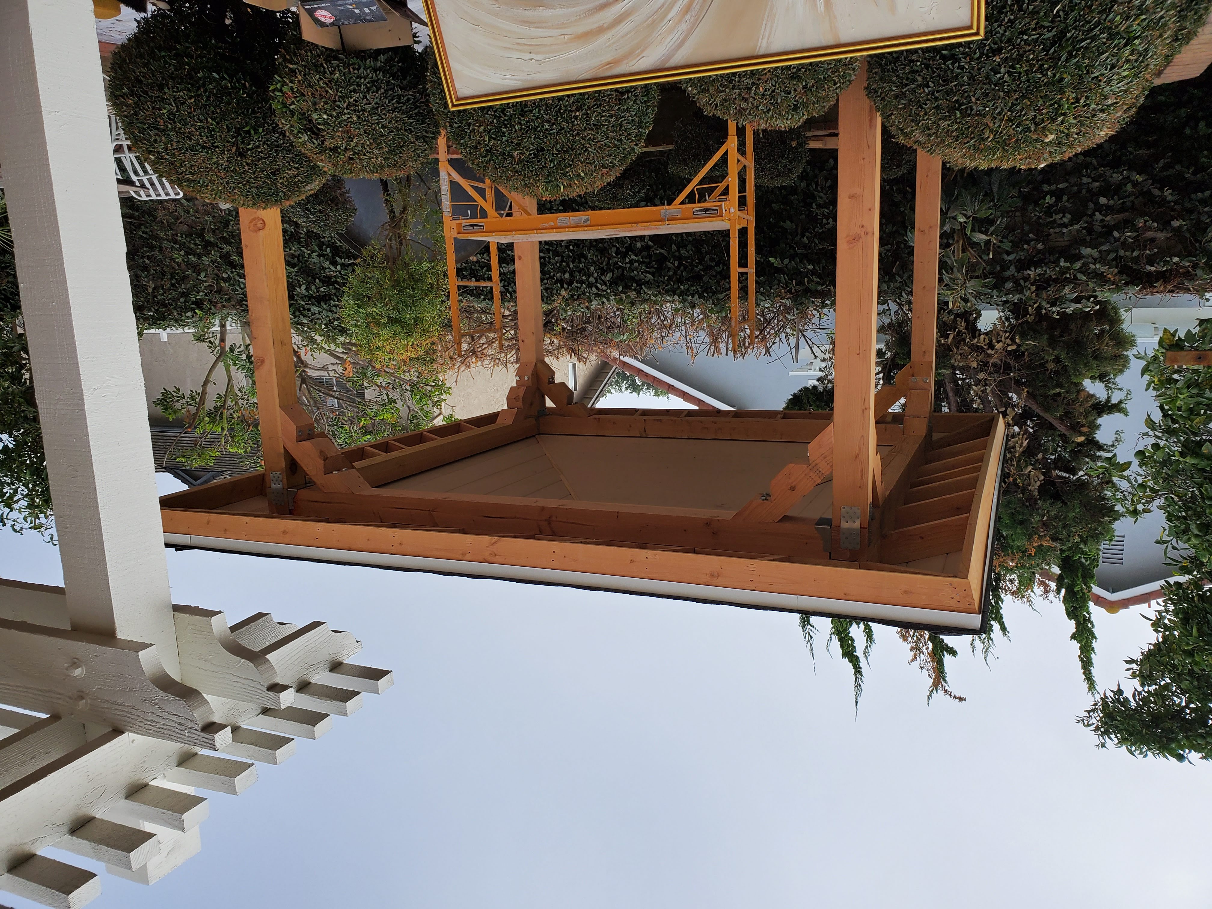 Garden Grove Backyard Patio Project - Main project image showing Custom wooden patio structure with pitched roof and pergola restoration.