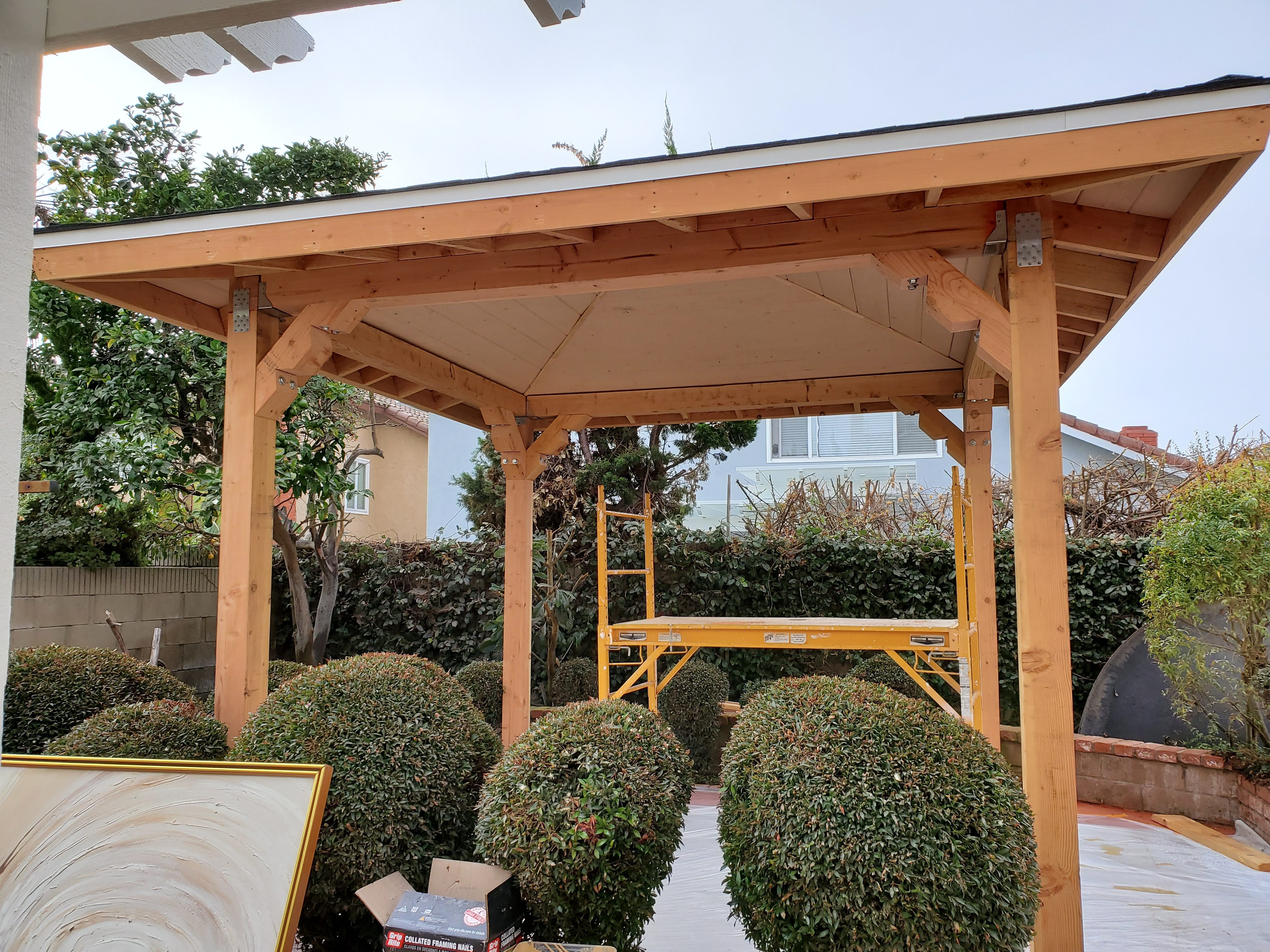 Garden Grove Backyard Patio Project - Additional detail image 1 of Custom wooden patio structure with pitched roof and pergola restoration.