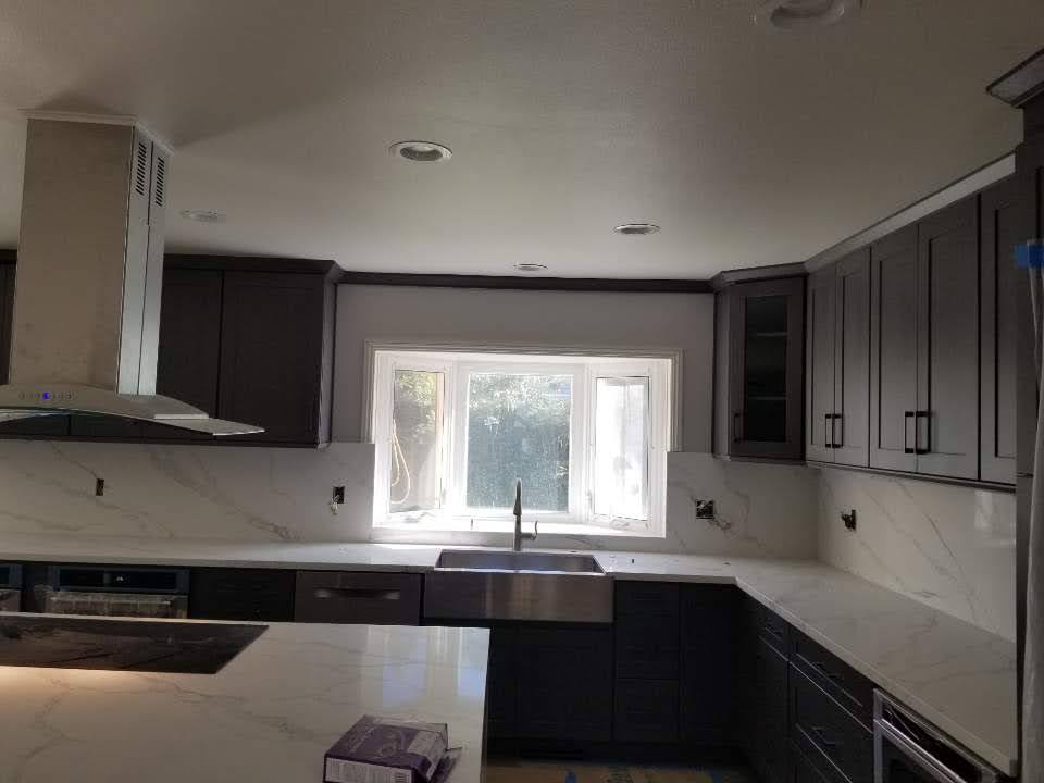 Fullerton Kitchen Remodel - Additional detail image 1 of Dark shaker cabinets with white quartz countertops and waterfall island.